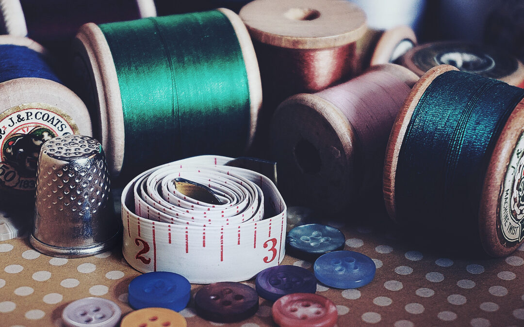 Pic showing rolls of thread, buttons and tape measure